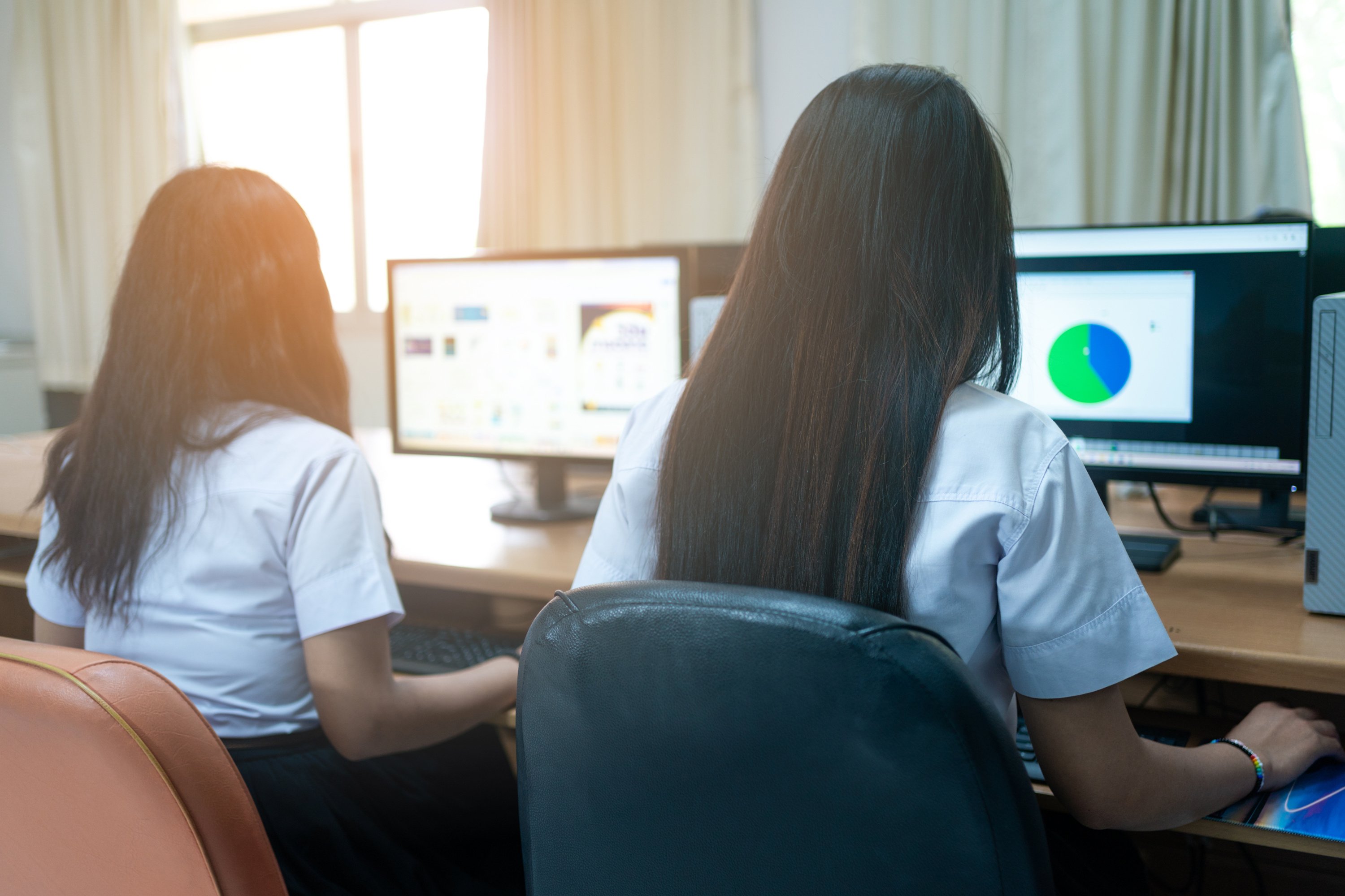 Asian college students attending computer class